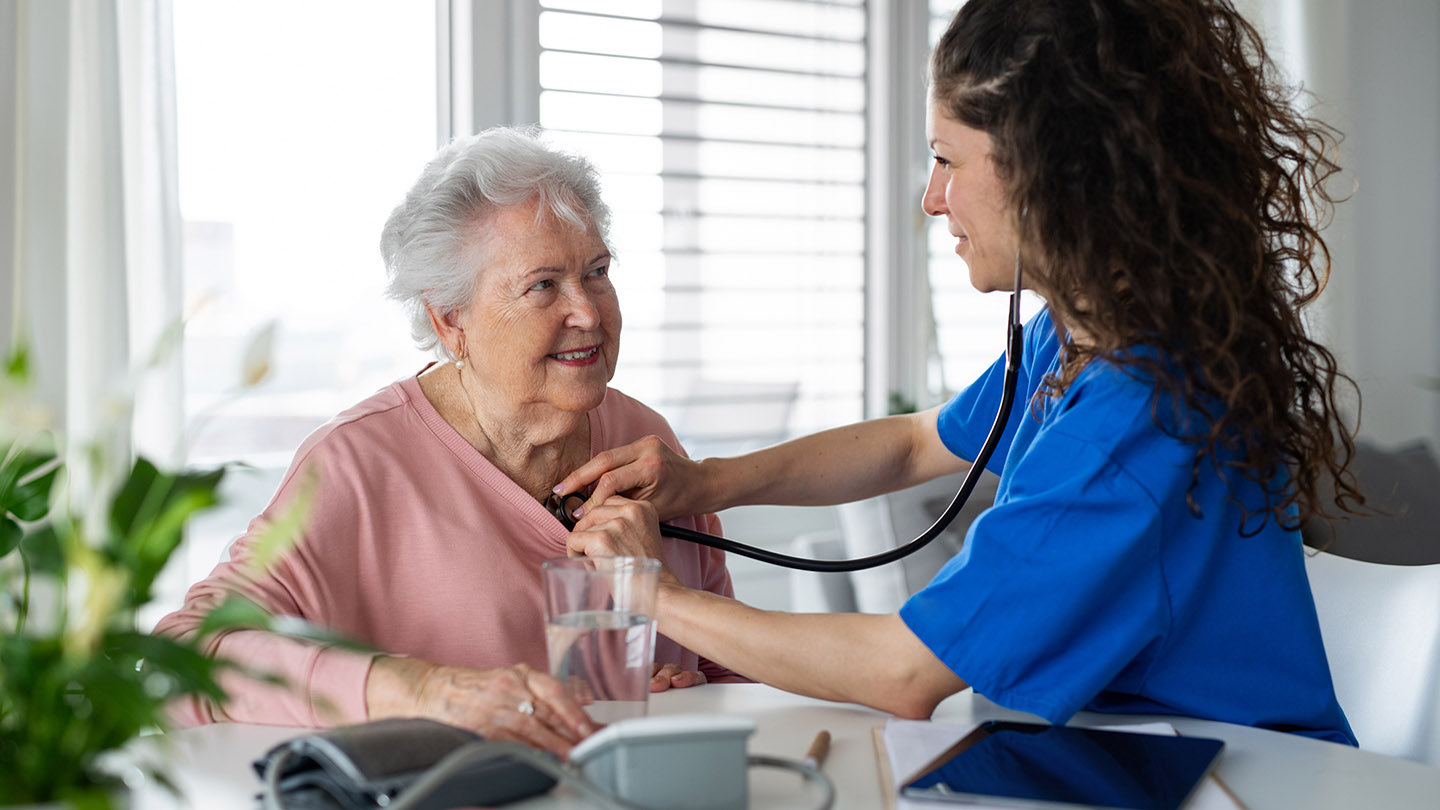 A nurse visiting patient in nursing home.
